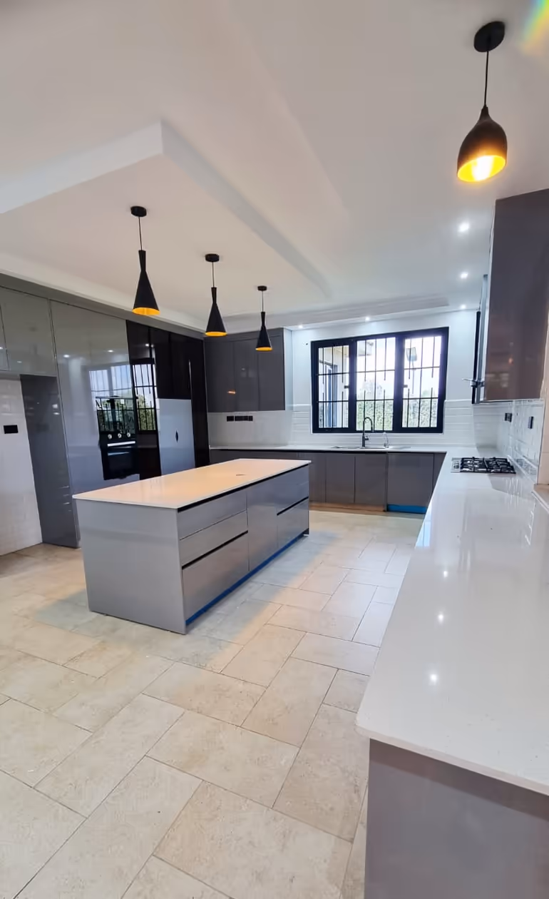 Modern Nairobi kitchen with polished granite counters and gleaming tile floors after cleaning