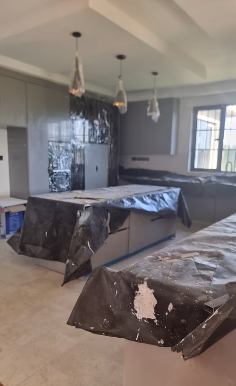 Newly installed Nairobi kitchen protected with tarps ready for Shine On post construction cleanup