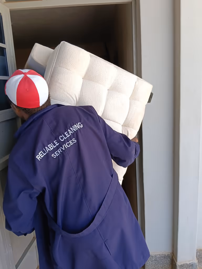 Shine On team member carrying a mattress for professional mattress cleaning in Nairobi