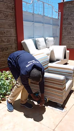 Shine On team member cleaning an outdoor armchair