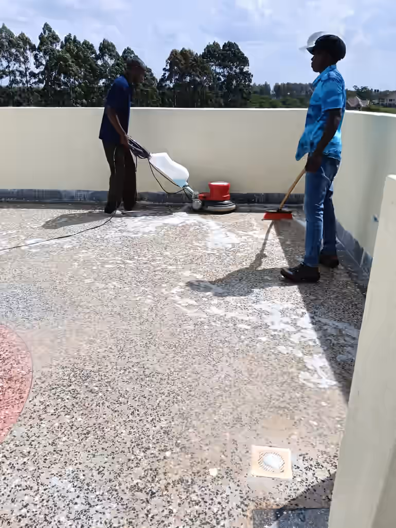 Shine On team using a rotary floor scrubber to deep clean a terrazzo rooftop terrace in Kiambu