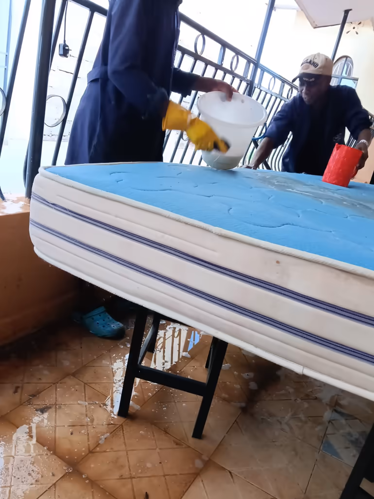 Shine On cleaners performing a deep foam mattress wash on a home balcony in Kiambu